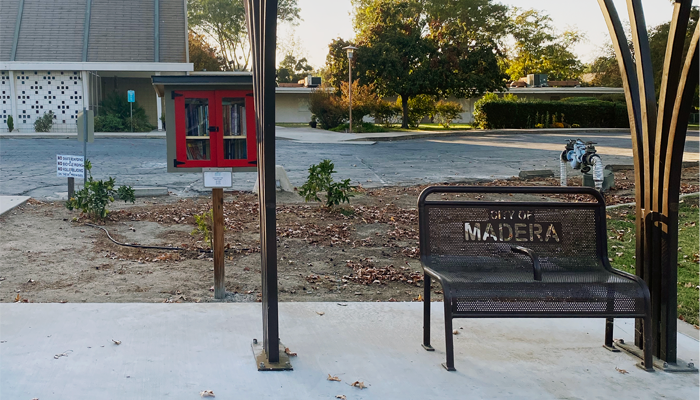 Red book exchange box next to bus stop